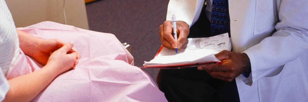 woman at the gynecologist, sitting with her doctor