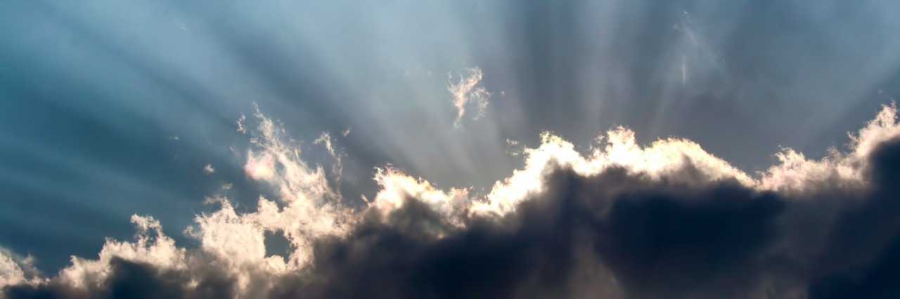 'Finding the Silver Lining' of Your Depression Crepuscular rays shining behind the cloud