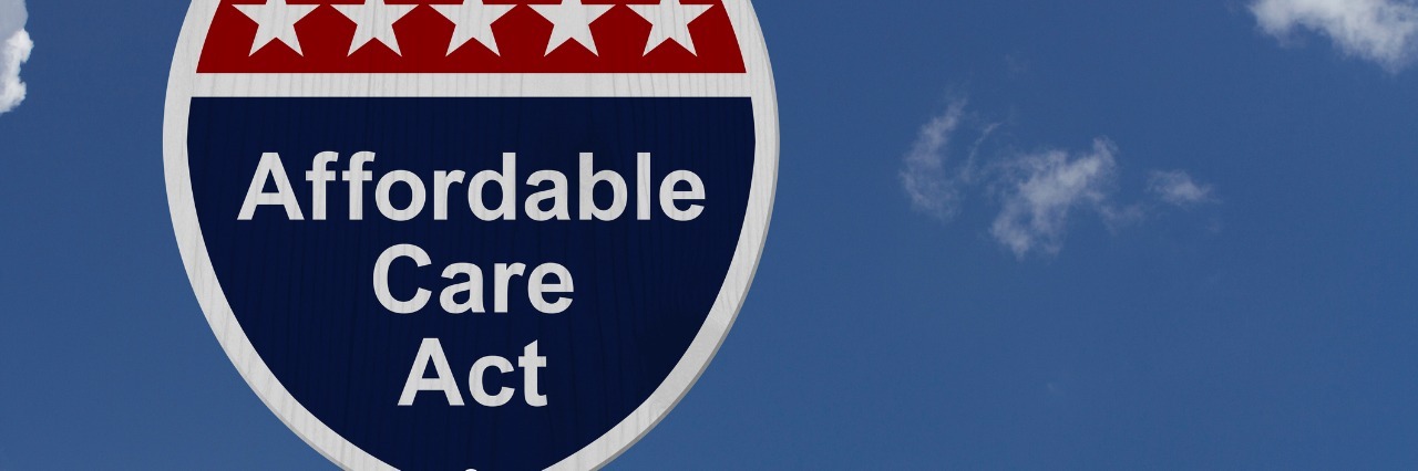 Affordable Care Act Sign, A red, white and blue highway sign with words Affordable Care Act and an arrow sign with sky background