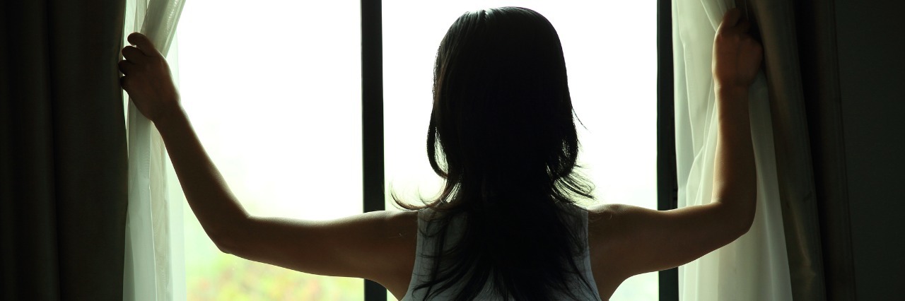 Depression: When Shame Keeps You From Talking About Mental Illness woman opening curtains