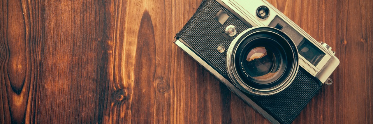 Why Depression Makes Me Believe I'm Not Successful Enough camera on a wooden table