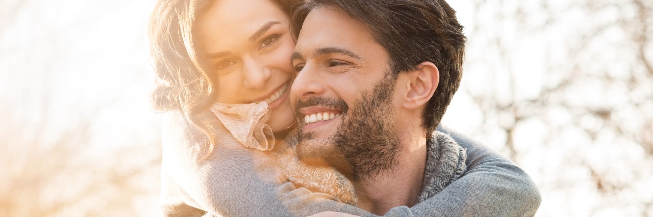 Tips for Dating With a Chronic Disease man carrying a woman on his back and walking around outside