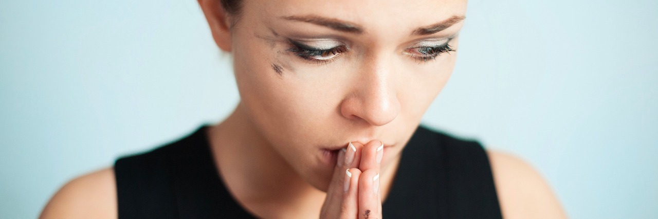 Post-Traumatic Stress Disorder: When You Can't Forget Your Trauma woman with her hands pressed against in lips