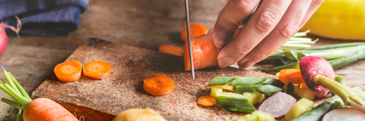 Anxiety So Bad It Makes You Think About Killing Yourself a woman chopping carrots in her kitchen