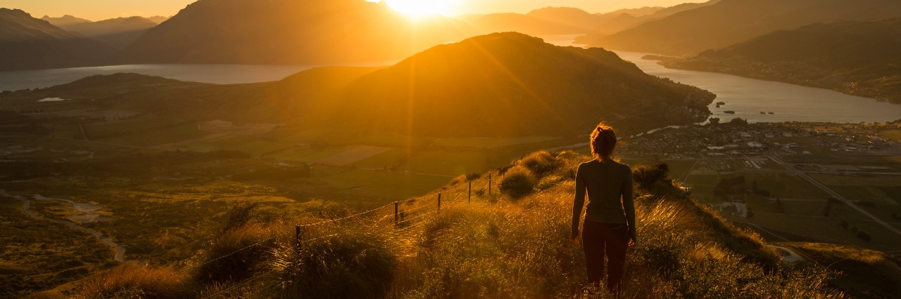 Woman silhouette at sunset on the mountain