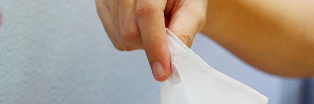 Hand Puling Tissue out of Box.