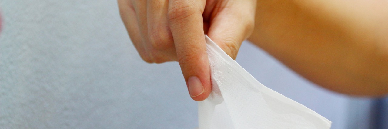 When Kids Should Stay Home From School With a Cold Hand Puling Tissue out of Box.
