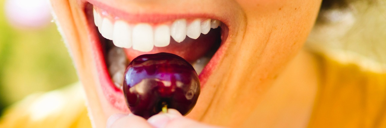 Anxiety Medications Can Change Your Appetite woman about to eat a cherry