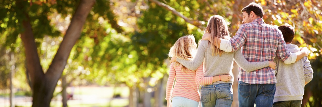 Feeling Thankful for Loved Ones as a Woman With Rheumatoid Arthritis family of four walking outside in autumn
