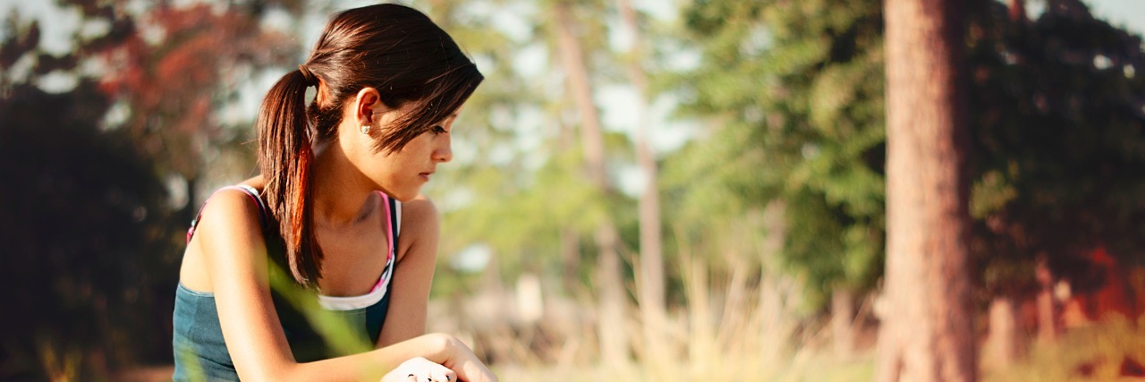 girl sitting alone in a park