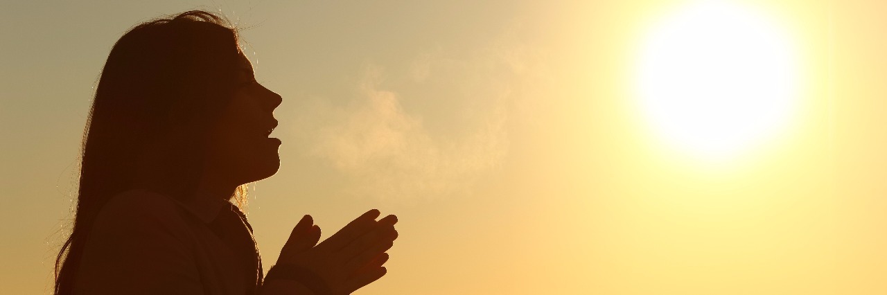 Letter to Read on Bad Days With Mental Illness woman taking in a deep breath in front of the sunrise