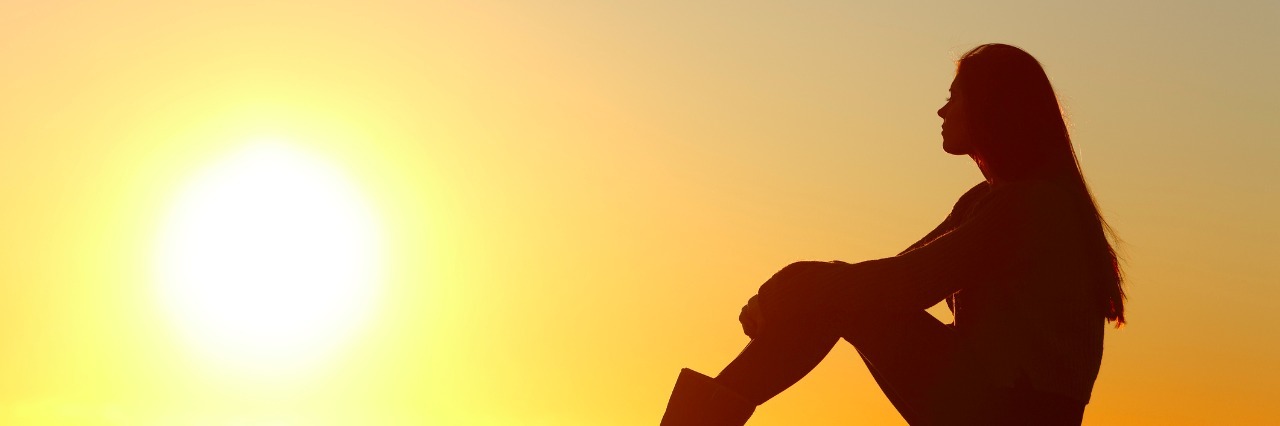 Schizoid Personality Disorder: What I Want People to Know a woman sitting by the ocean watching the sunset