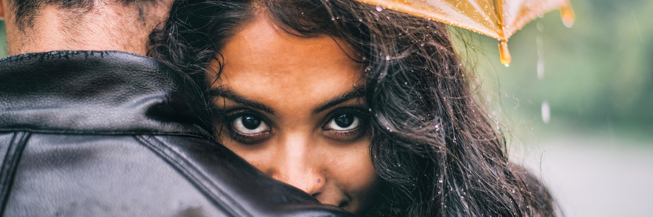 Saying Thank You to a Supportive Husband When You Live With Bipolar A woman leaning on her boyfriend, who's holding an umbrella