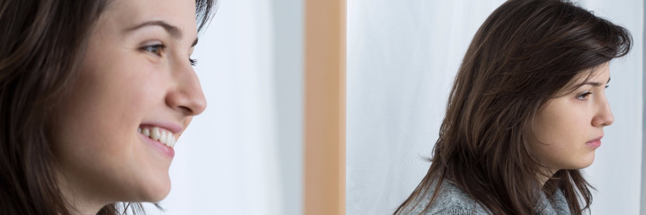 Chronic Pain: What 'I'm Fine' Actually Means girl smiling but frowning in the mirror