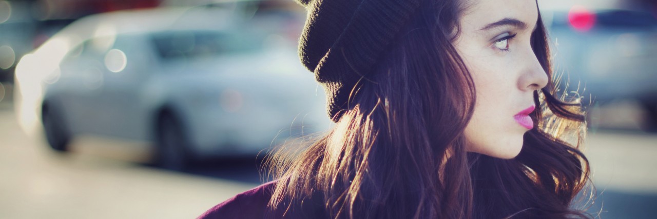 Stock image portrait of urban teen walking outdoors with a blank stare