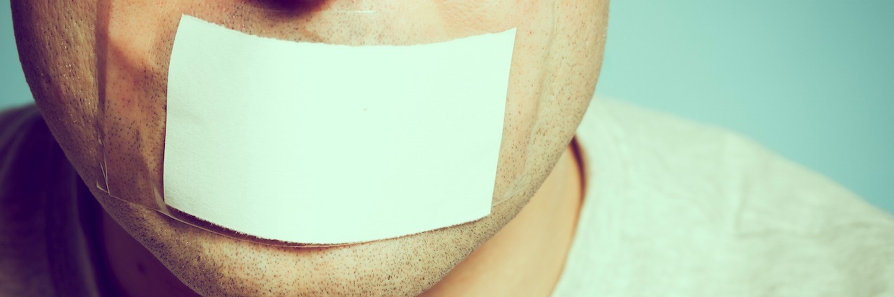 Depression Makes You Say and Thing Things You Don't Mean A man with a piece of paper taped over his mouth