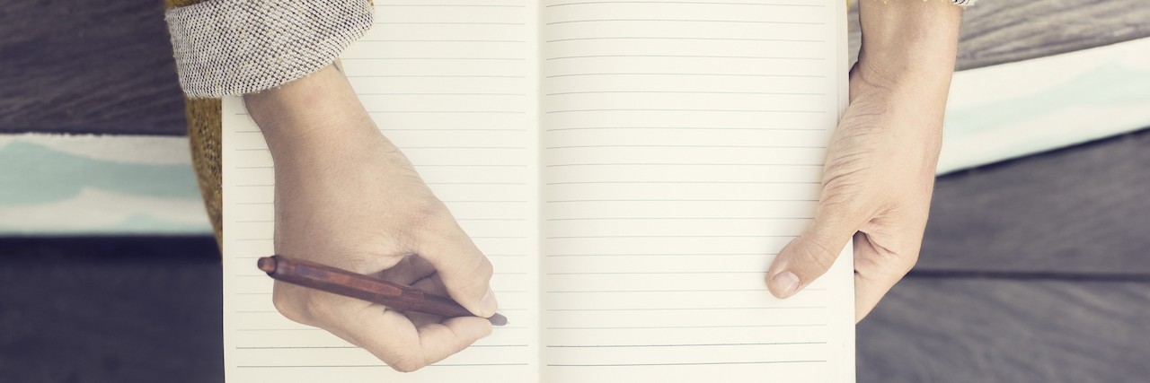 What to Know When You're Newly Diagnosed With Schizoaffective Disorder a woman writing in her journal