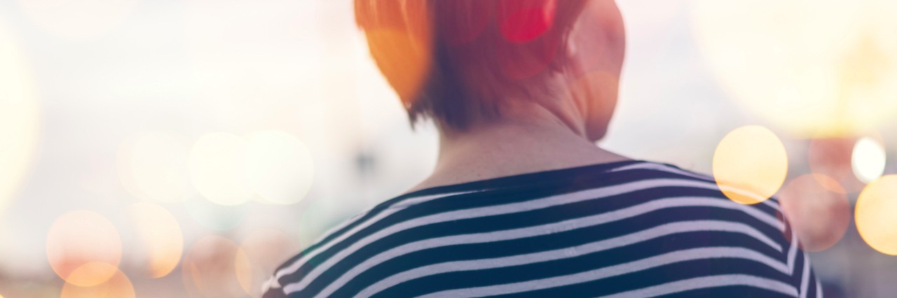 Exploring the Connection Between Psychosis and Self-Harm woman facing away walking