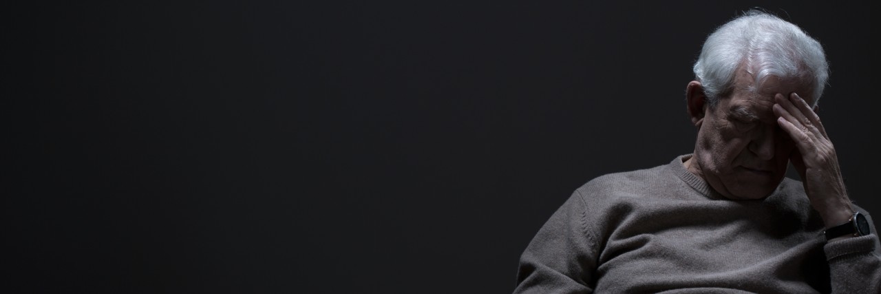 Talking About Painful Feelings You Hid as a Child Panoramic photo with dark background showing depressed elder man