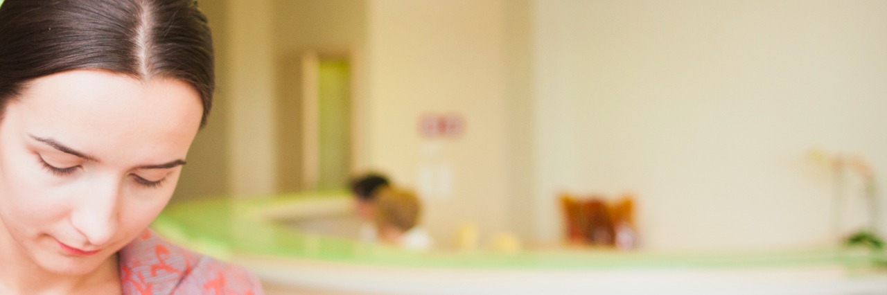 Recovering After a Suicide Attempt and Hospital Stay Woman woman leaving clinic with sad look on face