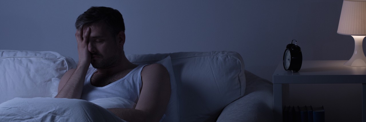 PTSD: What It's Like When Your Husband Has Nightmares man up at night sitting in bed