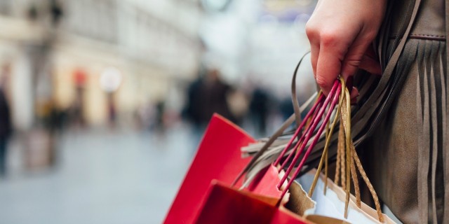 The Hardest Part of Holiday Shopping With a Psychological Disorder close up of womans hand holding multiple shopping bag handles