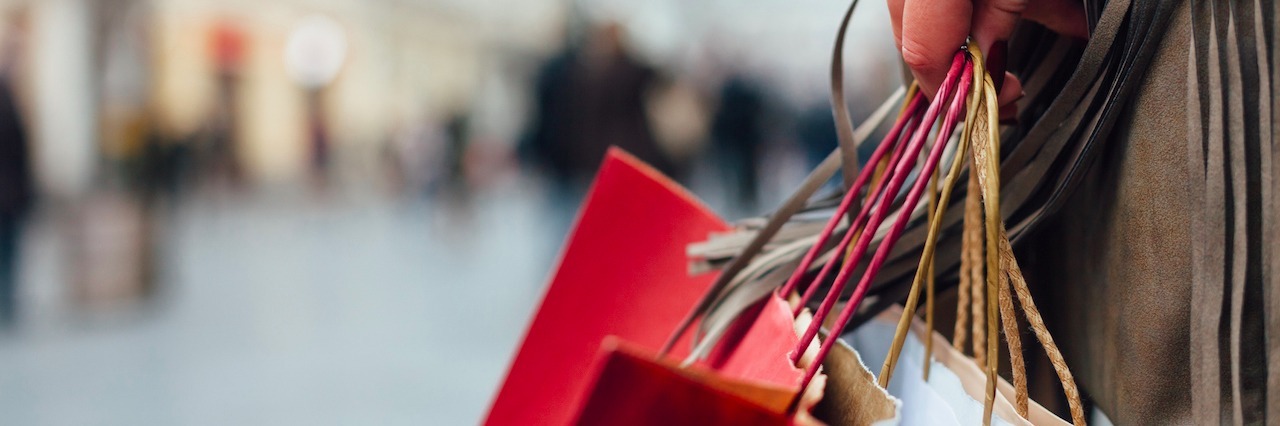 8 Holiday Shopping Tips for Someone With Social Anxiety a woman holding shopping bags