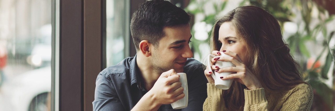 Navigating Relationships With Crohn's Disease couple drinking coffee and talking in a coffee shop