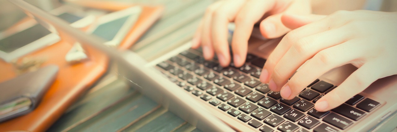 Why You Should Blog About Depression hands typing on a laptop