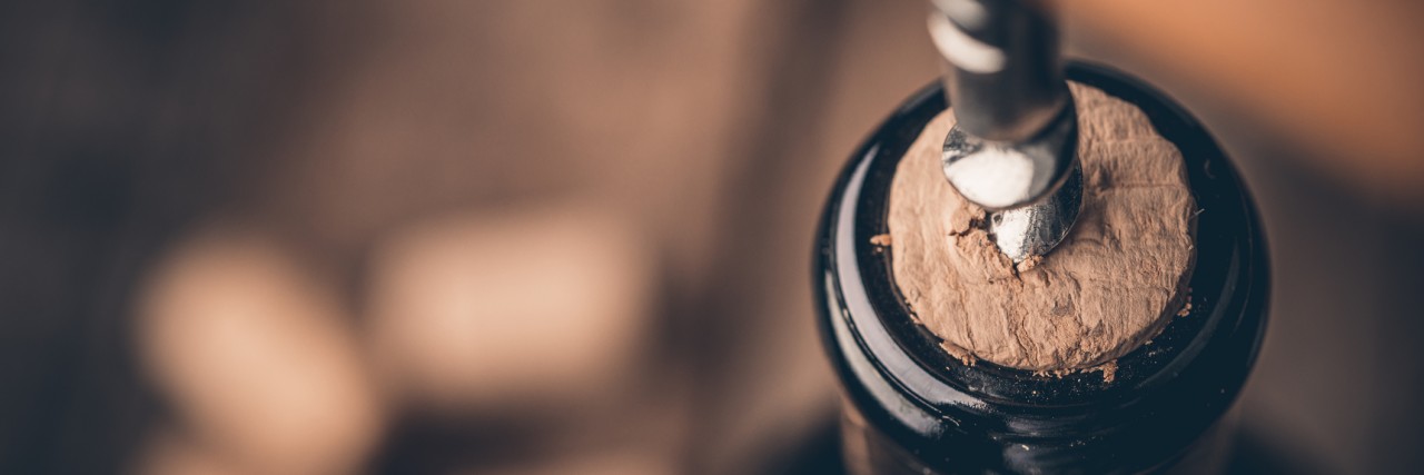 Addiction: 365 Days Since My Last Drink Corkscrew and bottle of wine on the board