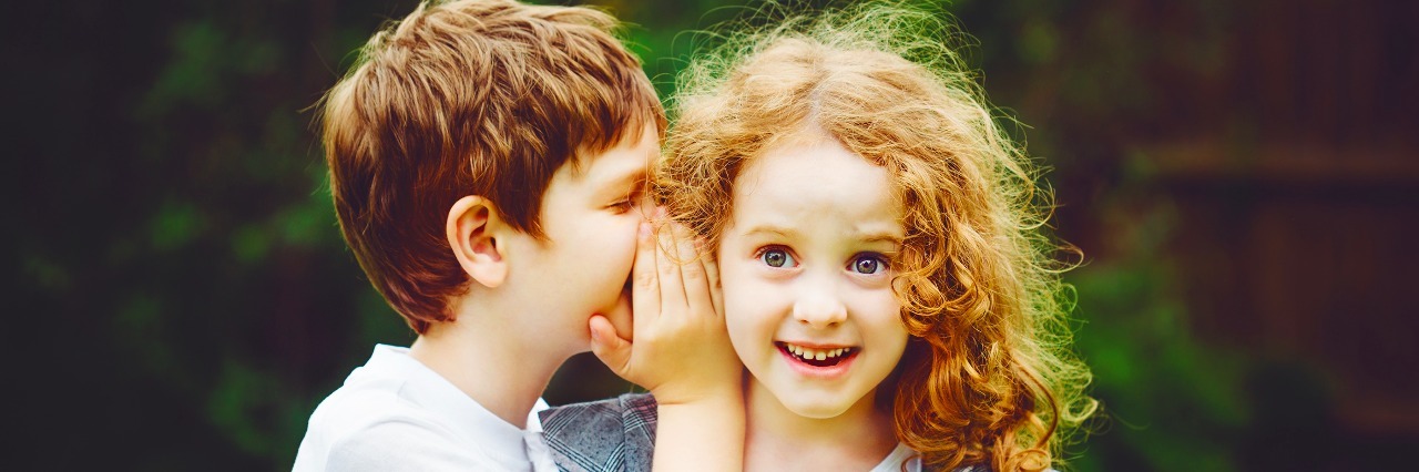 How to Help Your Child Navigate an Invisible Condition Little boy and girl whispers.