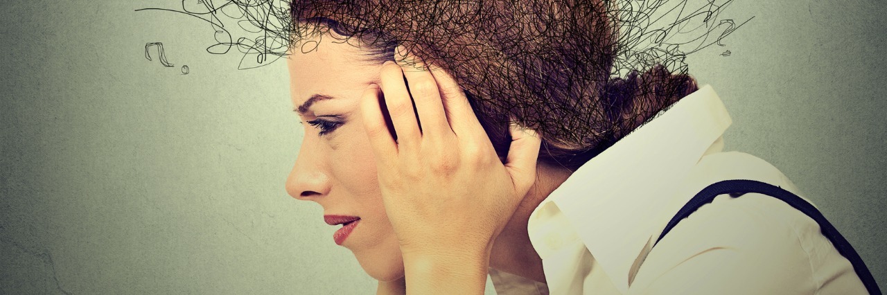 side profile of stressed woman holding her head