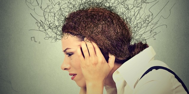 What I Really Want From Friends When I'm Feeling Anxious side profile of stressed woman holding her head