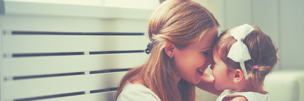 Pros and Benefits of Having a Child With ADHD Happy loving family. mother and child playing, kissing and hugg