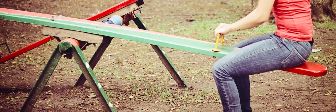 Mental Illness: Recovery Isn't Consistent woman on a see-saw