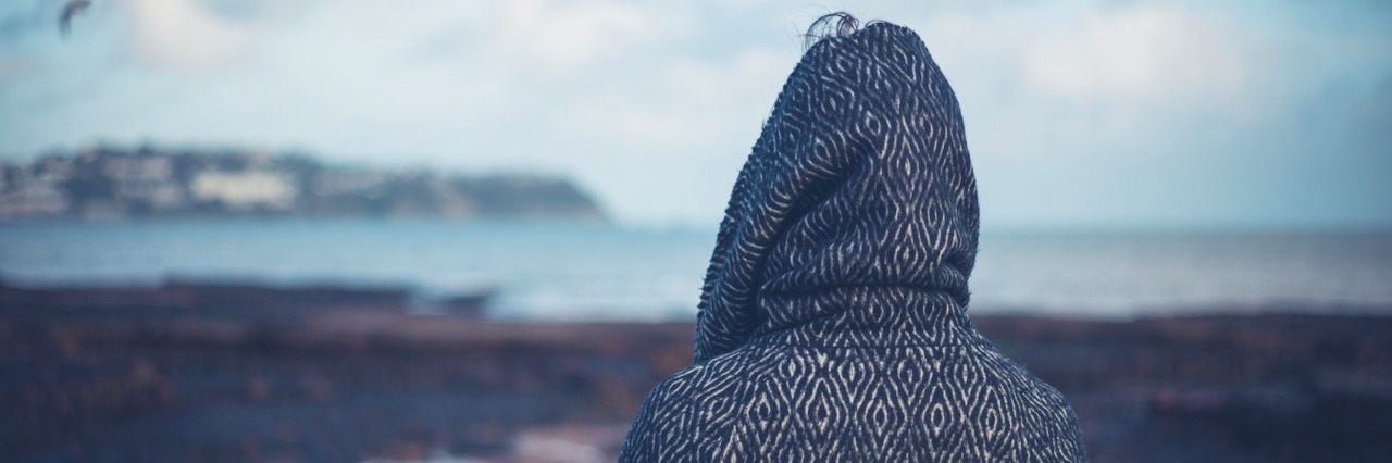 Explaining How I've Changed After the Loss of My Son Woman in hooded coat walking on beach