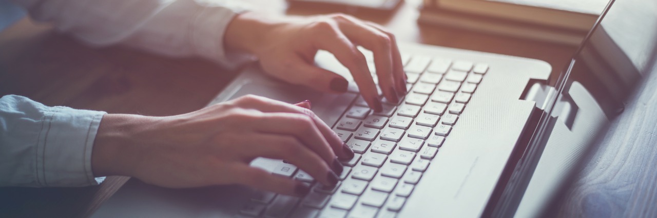 Sharing Non-Hodgkin Lymphoma Diagnosis With Friends, Family woman typing on a laptop