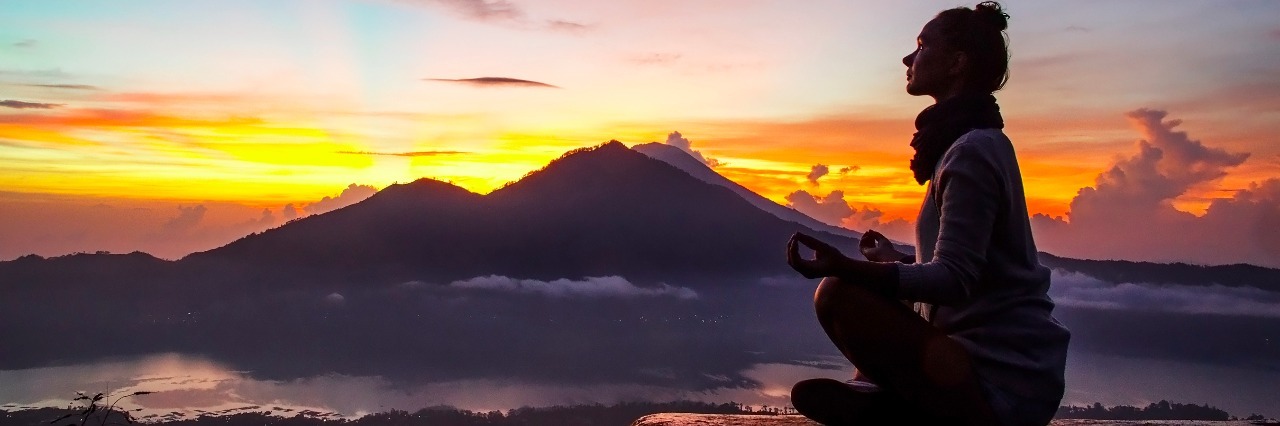My Bucket List After Lyme Disease Silhouette of a girl in the mountains at dawn. Stock image.