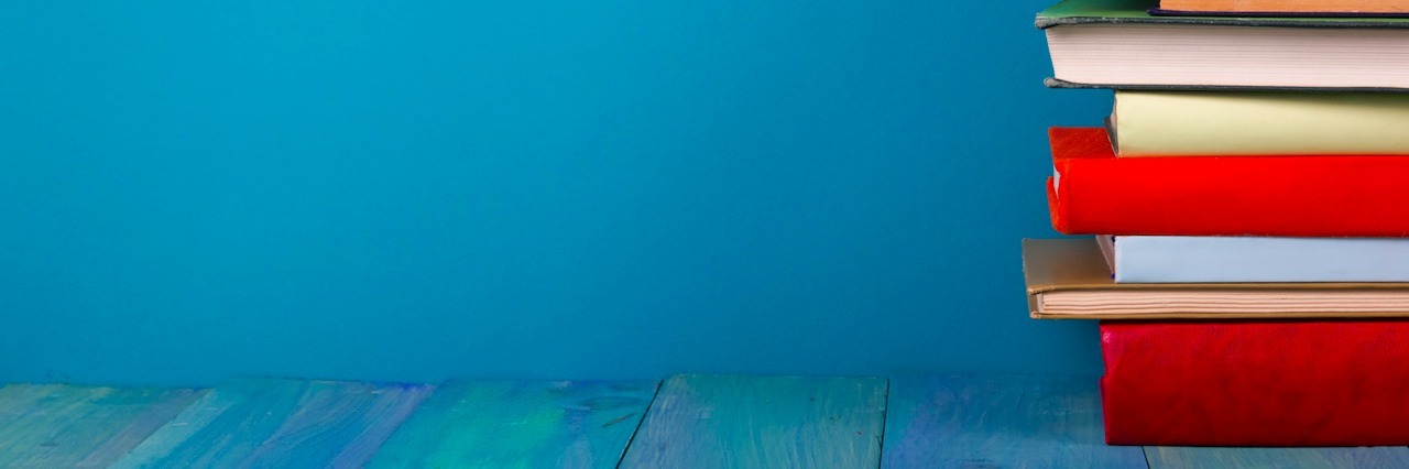 Why I Chose to Study Psychology in College With an Anxiety Disorder an apple sitting on top of a stack of books