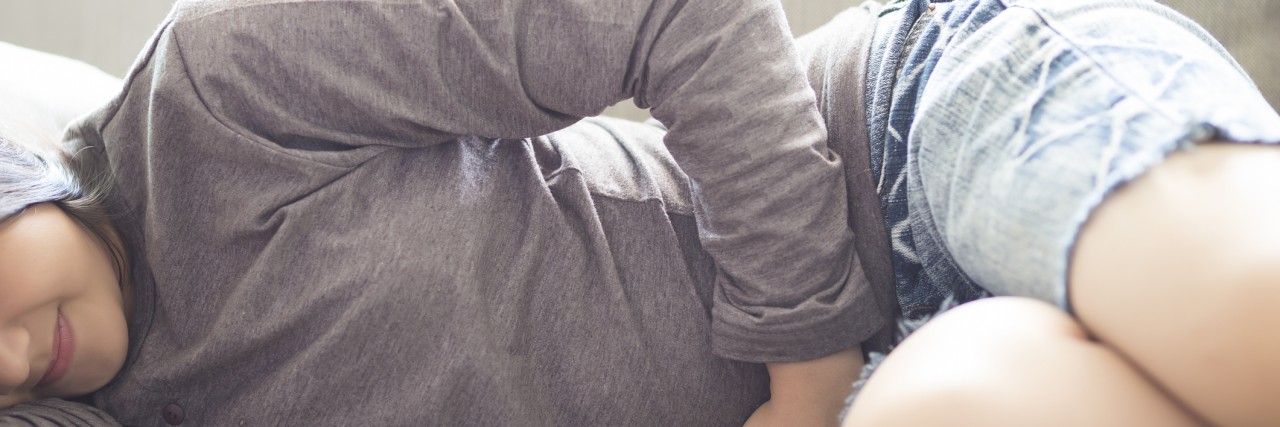 What It's Like Living With Complex Regional Pain Syndrome, the 'Suicide Disease' woman laying on couch