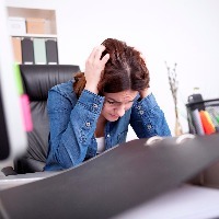 woman having a meltdown at her desk in the office