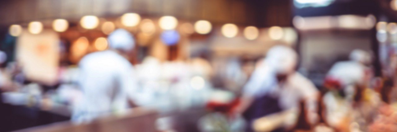 Waiter Quits Job at Steak By Melissa After Discrimination Over Eye Empty wood table with blur restaurant background,