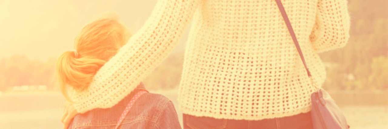 Autism: The World a Mother Wants for Neurodiverse Children mother and daughter standing together and looking out over lake