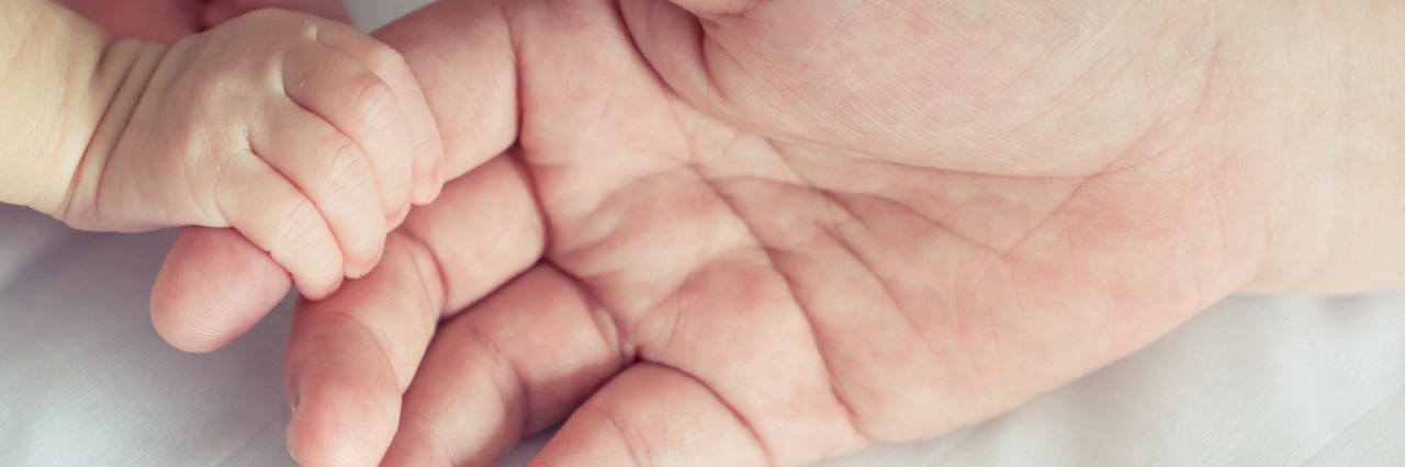 How My Daughter's Time in the NICU Changed Me Baby holding parent's finger