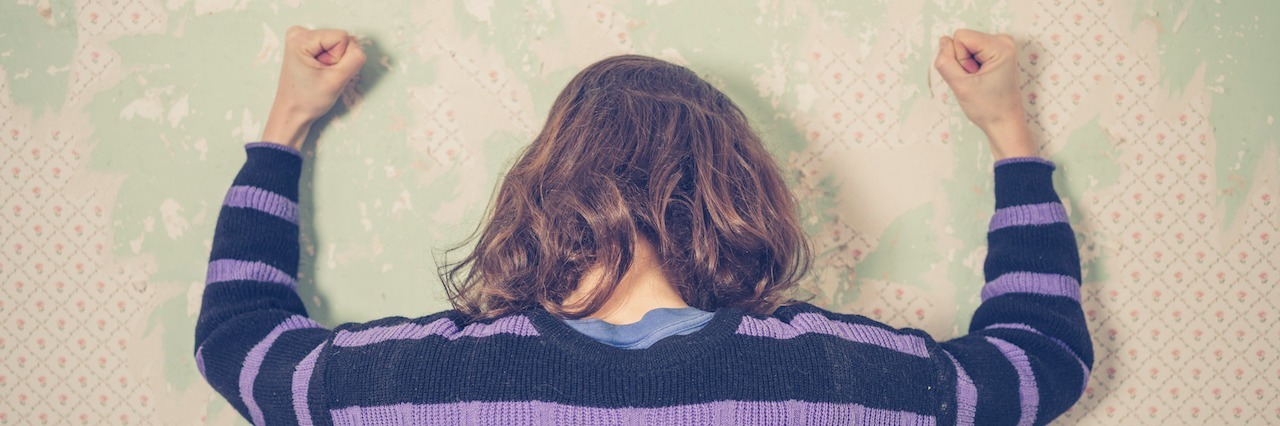 Letter to People Who Don't Understand Mental Illness a woman banging her fists against a wall