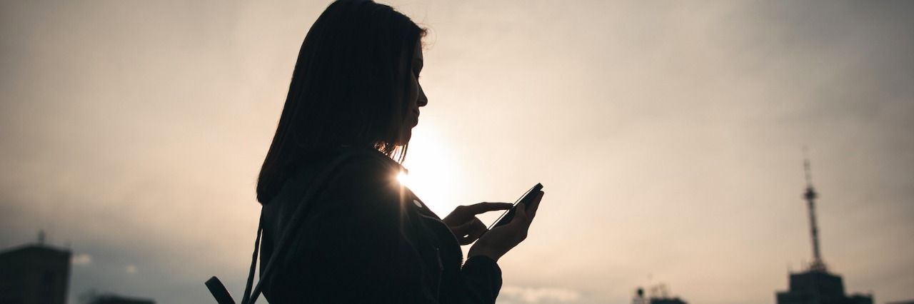 What 'Adulting' Means to Me as Someone on the Autism Spectrum Silhouette of woman looking at home in front of a city landscape