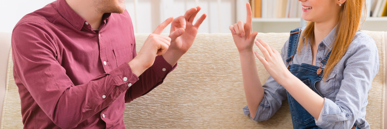 Things I Never Told My Friends About My Hearing Loss Deaf couple signing.