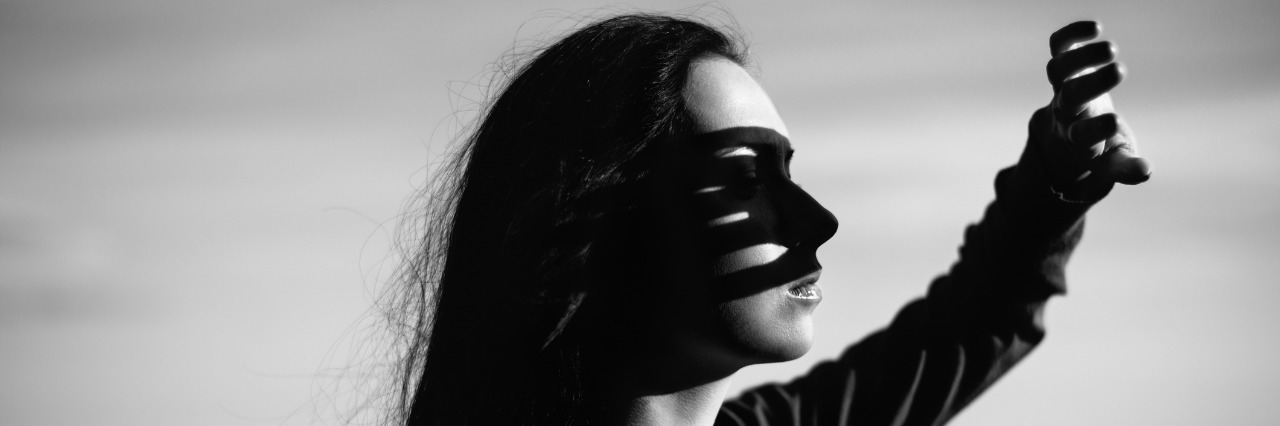 woman blocking sun from her eyes