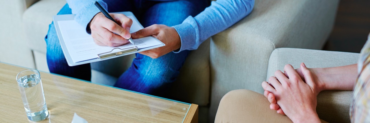 Bipolar II Disorder: The Fear and Uncertainty of a New Diagnosis close up of a psychologist taking notes during a therapy session with a patient