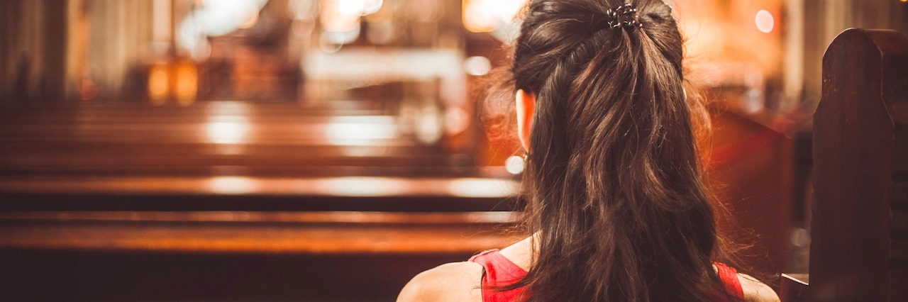 When the Church Makes You Feel Guilty for Having Anxiety young woman sitting in a church